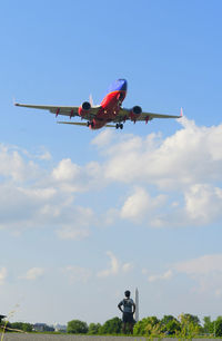 Low angle view of airplane against sky