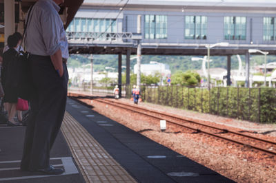 People walking on railroad station platform