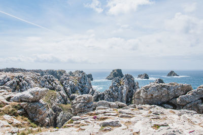 Rocks on beach against sky