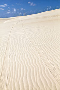 Sand dunes in desert against sky