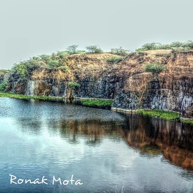 water, waterfront, tranquility, lake, tranquil scene, tree, reflection, clear sky, scenics, nature, beauty in nature, river, mountain, day, sky, idyllic, outdoors, non-urban scene, no people, calm