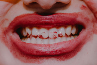 Close-up of woman face with messy lipstick