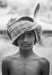 Close-up portrait of shirtless boy wearing towel on head