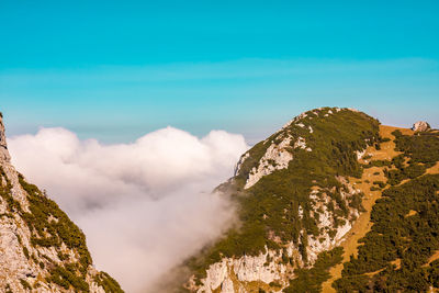 Scenic view of mountains against blue sky