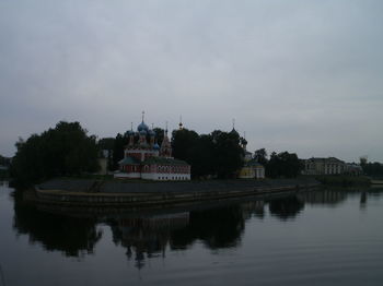 Reflection of building in lake against sky