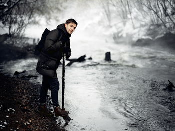 Full length of man standing by stream