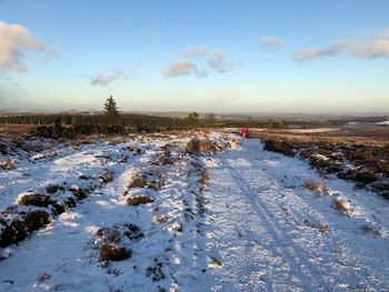 Snow covered landscape against sky