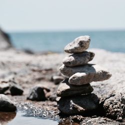 Stack of pebbles on beach against clear sky