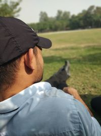 Rear view of man wearing hat on field