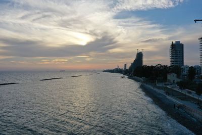 View of buildings against cloudy sky during sunset