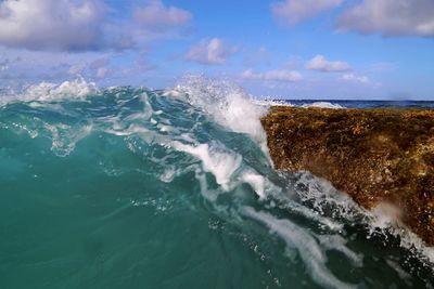 Close-up of waves in sea against sky