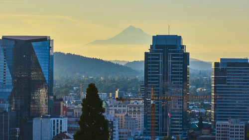 Modern buildings in city at sunset