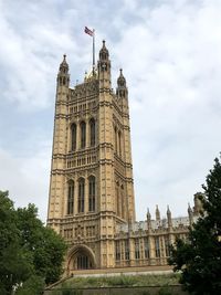 Low angle view of building against cloudy sky