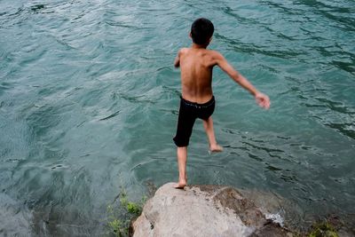 Full length of woman standing in water