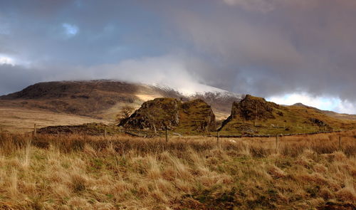 Scenic view of mountain against cloudy sky