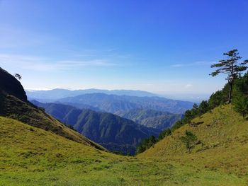 Scenic view of mountains against blue sky