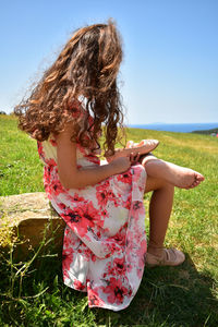 Rear view of woman standing on field