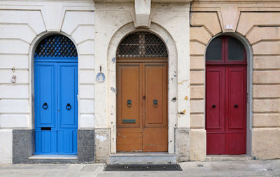 Traditional vintage painted wooden door and exterior in malta. entrance to typical maltese houses.