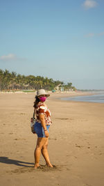 Full length of woman on beach against sky