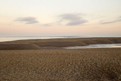 Scenic view of beach against sky during sunset