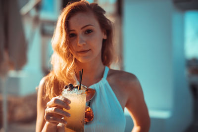 Close-up portrait of young woman holding ice cream