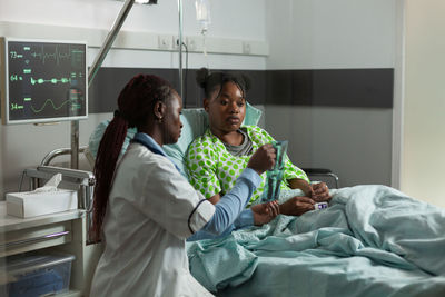 Doctor showing medical x-ray to patient in clinic