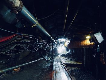 Illuminated railroad tracks in tunnel