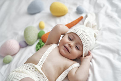 High angle view of baby girl on bed