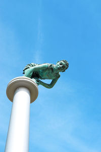 Low angle view of statue against blue sky