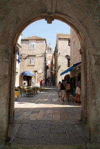 People on street amidst buildings in city