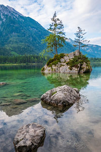 Scenic view of lake by mountain against sky