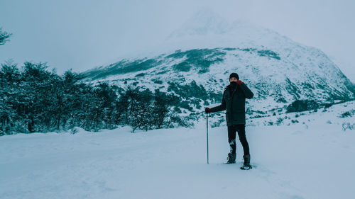 Man standing on snow covered land