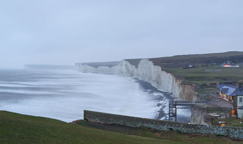 View of seven sisters cliff by sea against sky