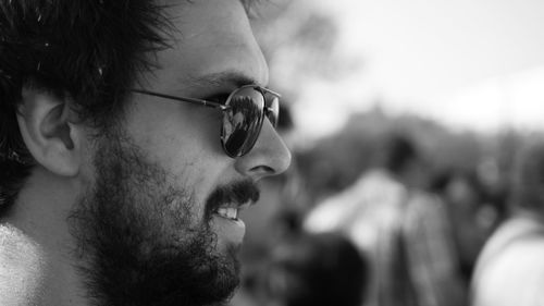 Close-up profile view of confident man with beard wearing sunglasses