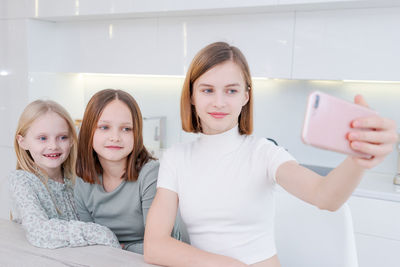 Portrait of smiling mother and daughter at home