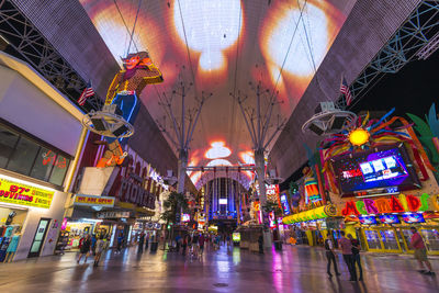 Group of people in illuminated building at night