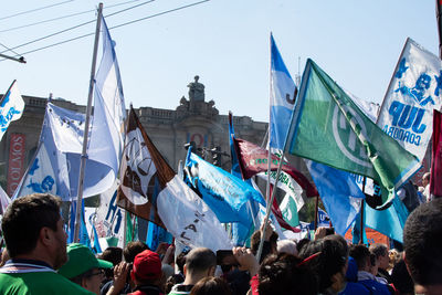 Group of people against buildings in city