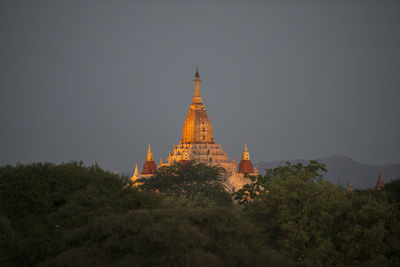 Illuminated historic temple against sky at dusk