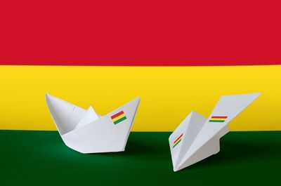 Close-up of paper flag against colored background