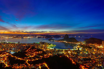 High angle view of city lit up at night