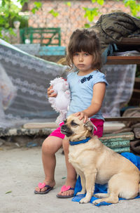 Full length portrait of girl with dog