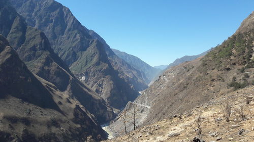 Scenic view of mountains against clear blue sky