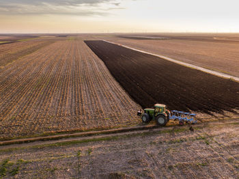 Serbia, vojvodina. tractor plowing field in the evening