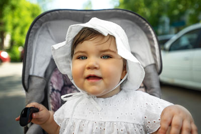 Portrait of cute baby girl in car