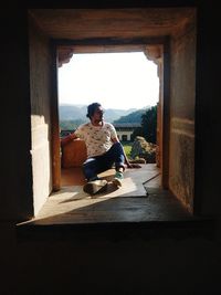 Man sitting in doorway of fort