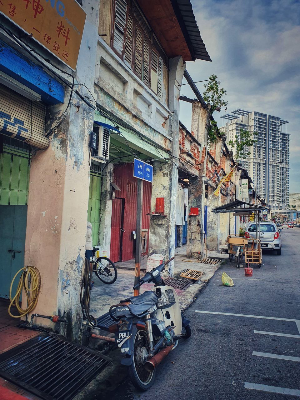 STREET AMIDST BUILDINGS AGAINST SKY