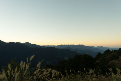 Scenic view of silhouette mountains against clear sky