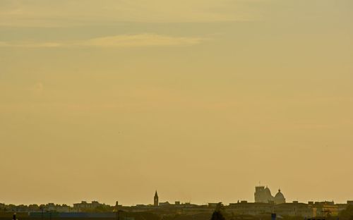 Silhouette of buildings against sky during sunset