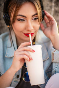 Portrait of a young woman drinking drink