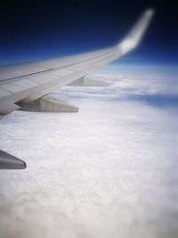 Airplane flying over clouds in sky